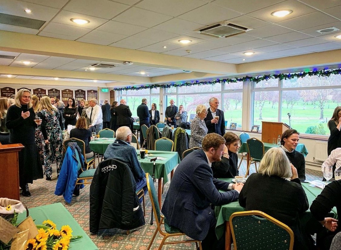 Guests gathering informally around tables at a celebration of life arranged by Memories Funeral Service