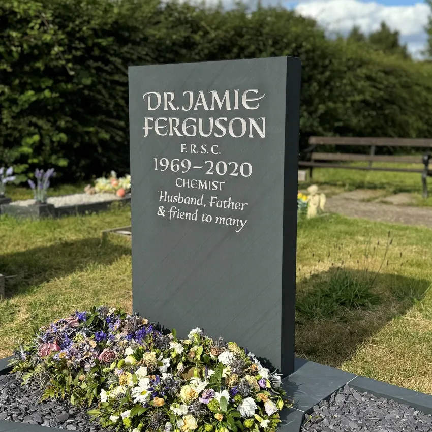 Traditional polished black granite memorial with gold lettering and decorative roses